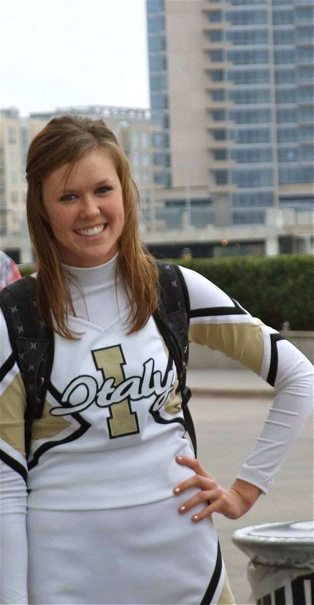 Image: Rossa’s all smiles — Italy High School cheerleader Kaitlyn Rossa stands tall outside the American Airlines Center in Dallas before entering the hanger.