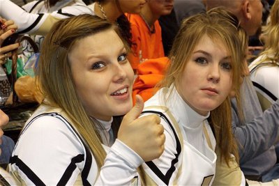 Image: “Cheese” and nachos — IHS cheerleaders Casandra Jeffords and Taylor Turner enjoy a snack in the stands before getting their cheer on for the Gladiators.