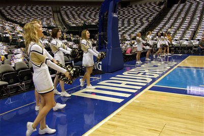 Image: Cheerleaders cheering — The IHS cheerleaders keep the cheers coming from under the basket inside the AAC.