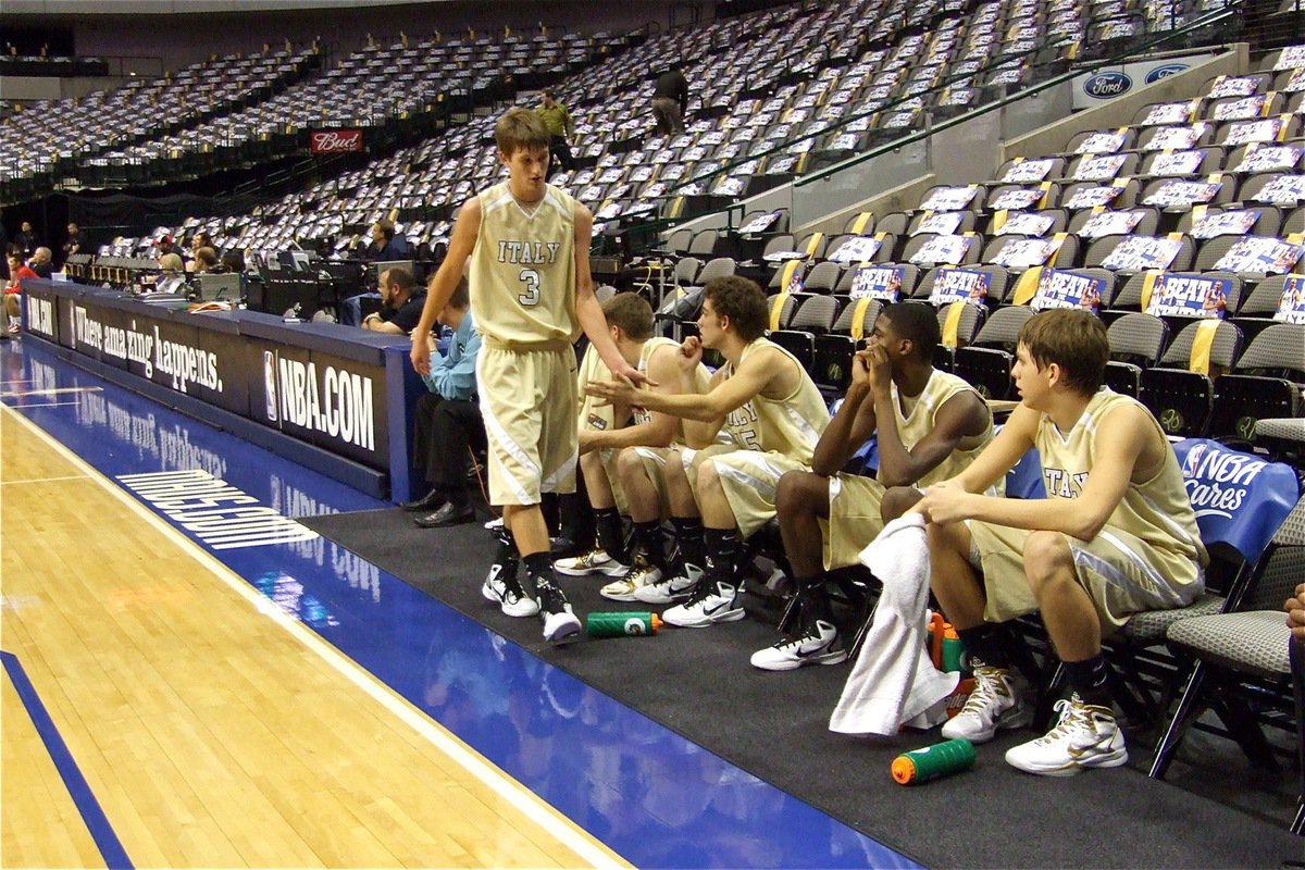 Image: Good job — Jase Holden(3) gets a low-five from teammate Brandon Souder as he exits the floor.