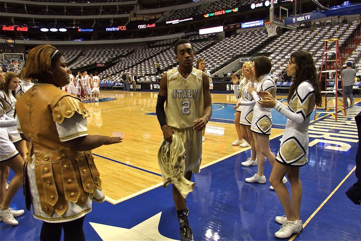 Image: Heath’s exhausted — Gladiator senior Heath Clemons(2) leaves the Mavericks’ court taking a lifetime of memories with him as the IHS cheerleaders congratulate him on a hard fought game.