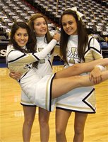 Image: Cheer crazies — Morgan Cockerham and Anna Viers lift fellow IHS cheerleader Beverly Barnhart after the game inside the American Airlines Center.
