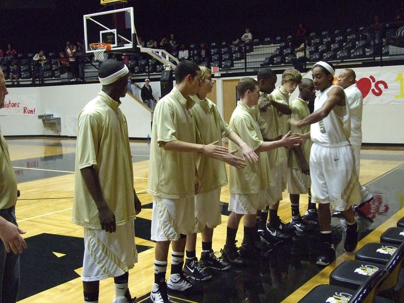 Image: Senior Dontavius Clemons — Italy’s #5 Dontavius Clemons receives a hand from teammates and fans as he enters his the game.