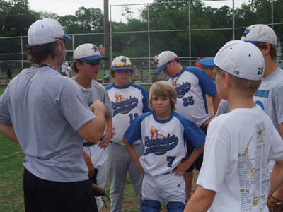 Image: Renegades huddle — Coach Jason Moore tries to inspire the troops as they play a double header in order to get prepared for the World Series in Colorado.
