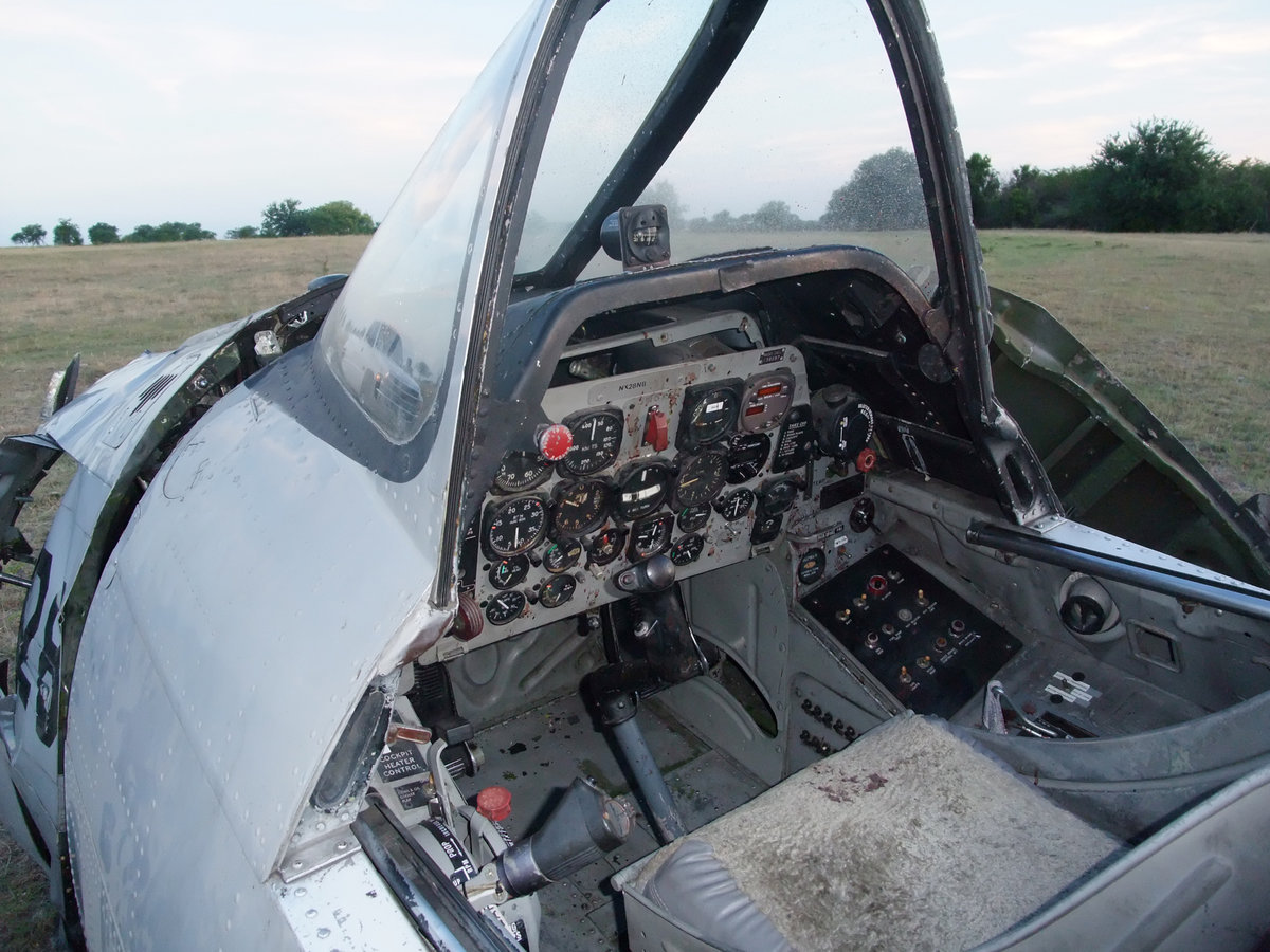 Image: Pilot crawls out — The pilot was able to crawl away from the downed aircraft but not without injury.