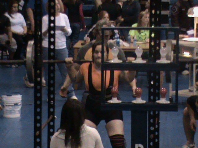 Image: Squat time — Kaytlyn Bales gets comfortable under the bar in the squat cage during the Rice powerlifting meet.