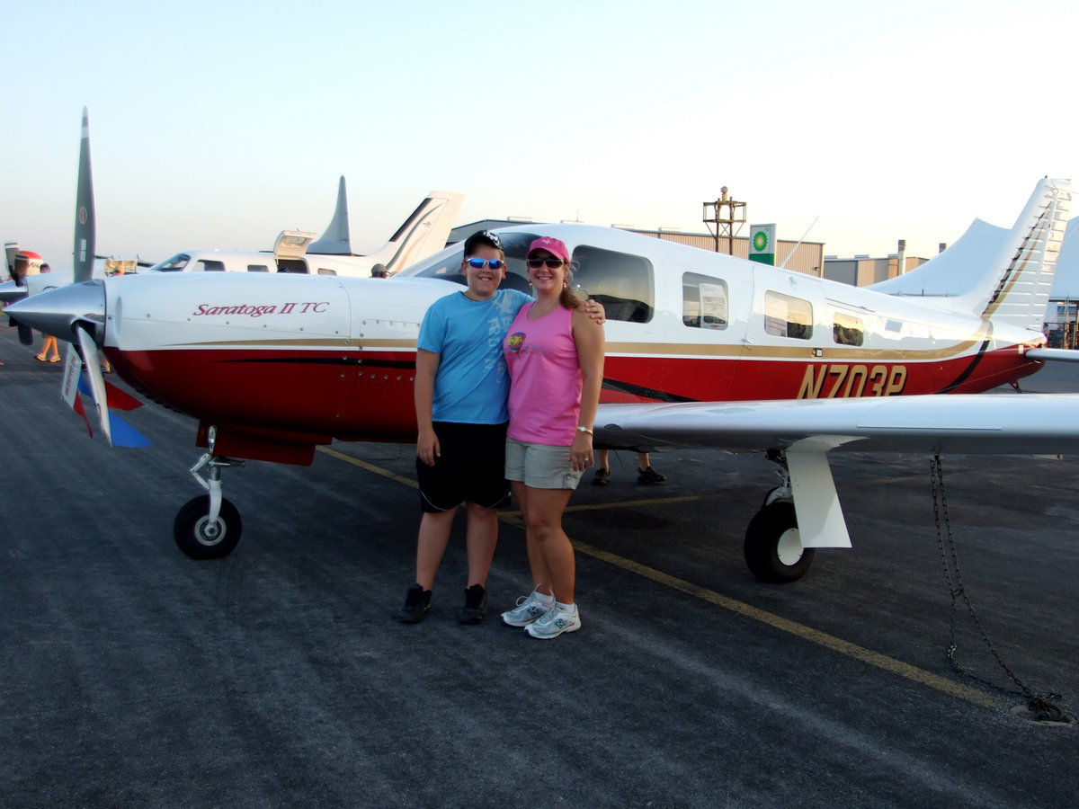 Image: Chance and Chantilly Berryman — Chantilly Berryman and her son Chance taking a picture by one of the planes.