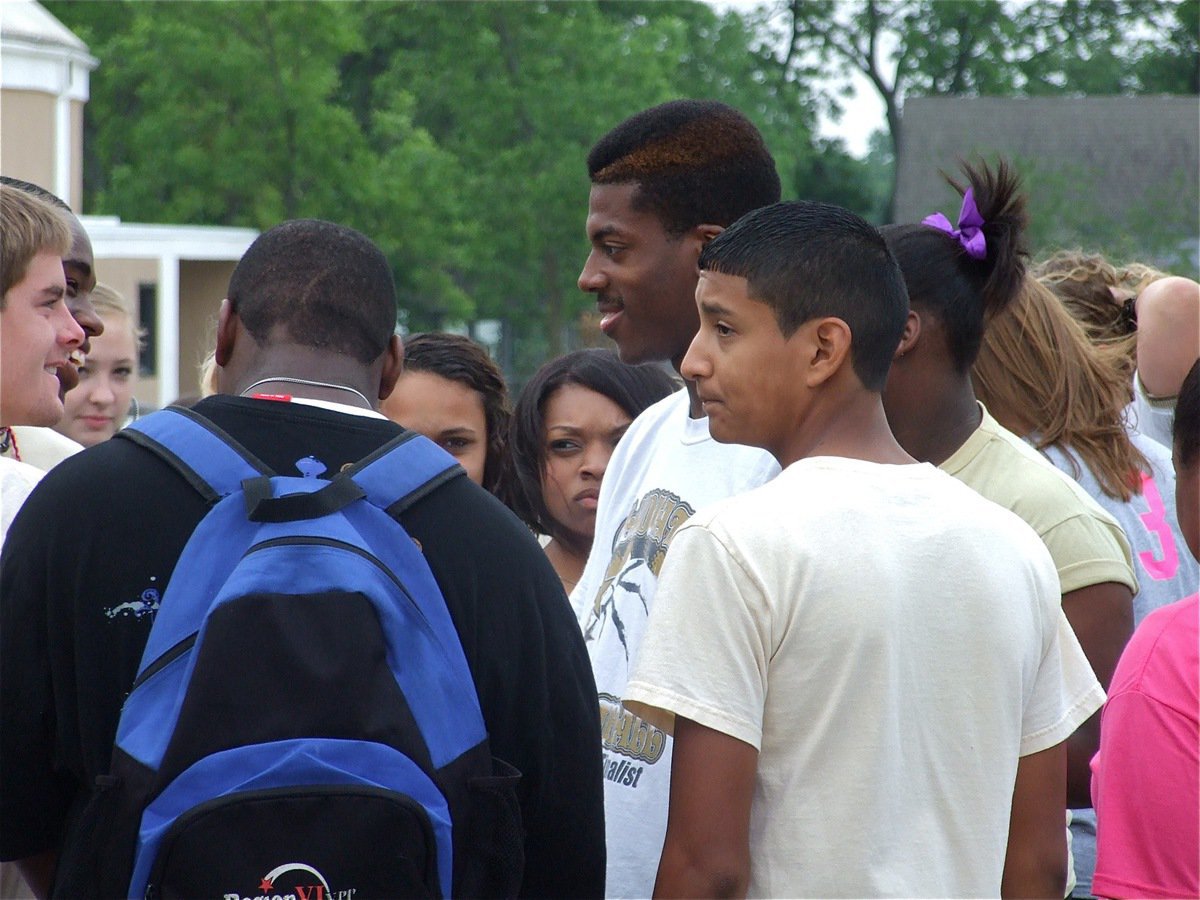 Image: Laughing with John — Track teammates joke with John Isaac before he leaves for Austin.