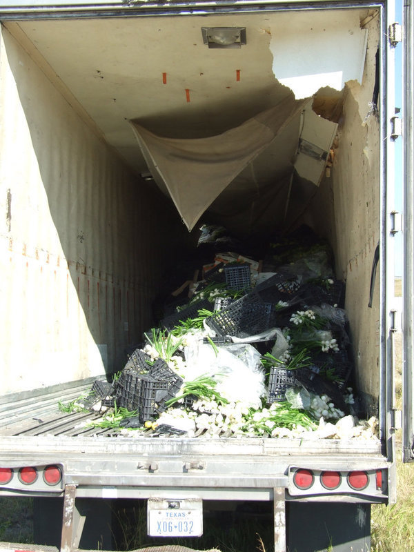 Image: Fresh Produce — There were onions, carrots, guavas, bananas, cilantro, green tomatoes and much more produce spilled in the truck. South Coast Produce company donated it to local restaurants and local food banks.