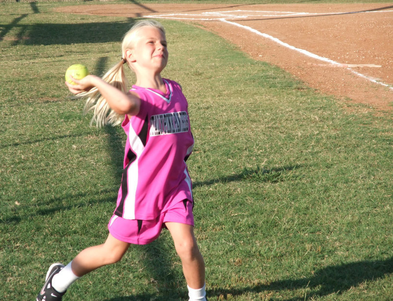 Image: Lacy launches — Lacy Mott throws before the game against Milford.