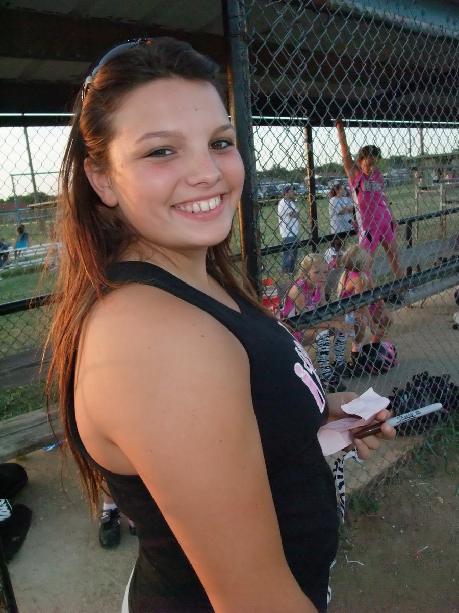 Image: Cori pitches in — Current IHS Lady Gladiator and All-District softball player, Cori Jeffords, pitches in by helping the Italy Pink Panthers manage their batting order. It wasn’t that long ago that Cori was a player in the IYAA herself.