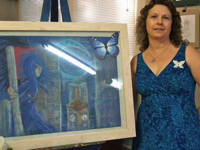 Image: Cynthia Nance — Cynthia is standing next to one of her daughters beautiful artwork.