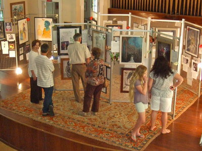 Image: The house was packed — These onlookers were enthralled with Shelly Nance’s works of art.