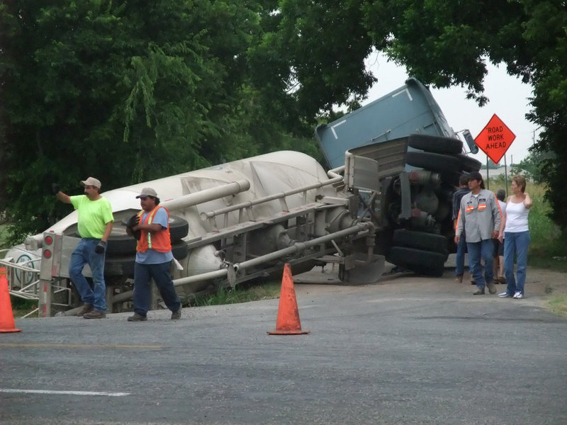Image: Keith Helms takes control at the scene of the twisted 18-wheeler — Keith Helms of Helms Garage from Italy secures the scene of the stranded 18-wheeler by diverting traffic and directing the equipment it would take to resolve the situation.