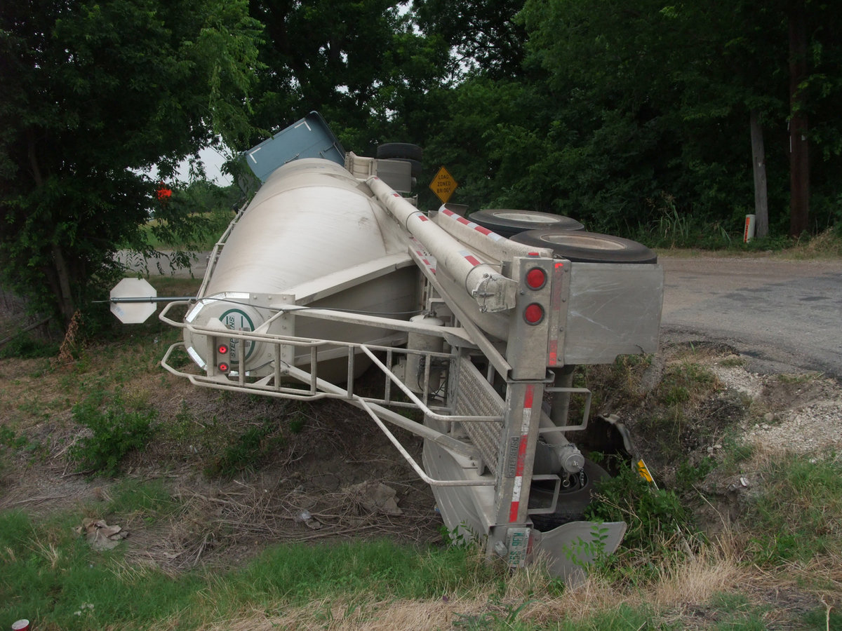 Image: Oops! — That’s a truckload filled with a powdered cement mix that now has a major problem that occured as it was on it’s way to help make minor repairs to a road between Waxahachie and Forreston.