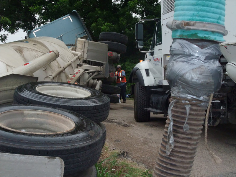 Image: Salvaging the load — The vacuum truck temporarily held the concrete mix before pumping it into a separate 18-wheeler for transport.