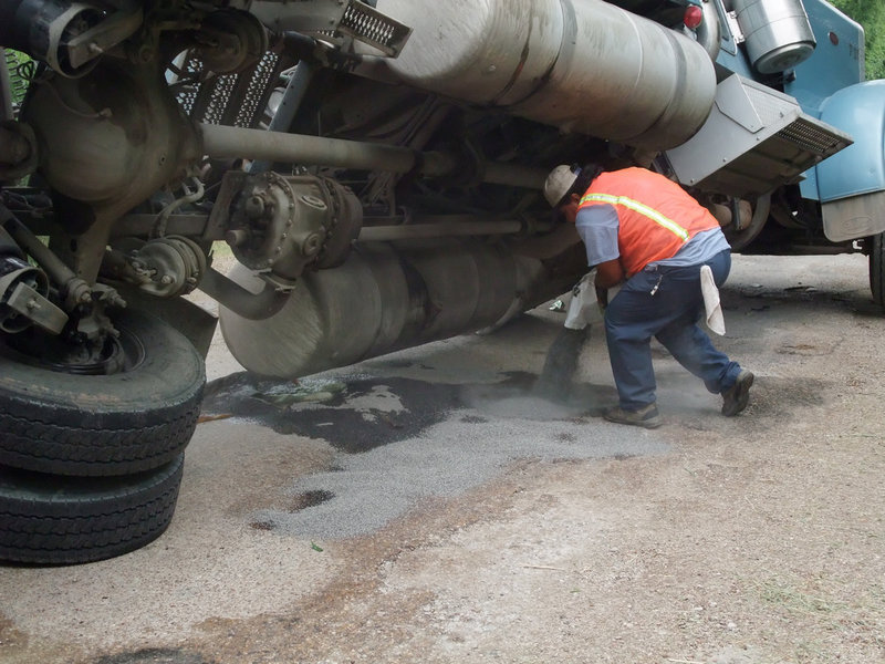 Image: Containing the leak — Jesus Martinez takes a risk to ensure the gas leak stays contained.