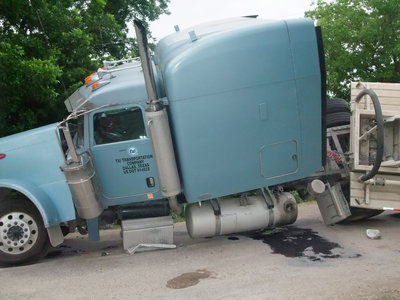 Image: Mangled truck cab — The driver was not hurt in this ordeal but his rig was badly damaged.