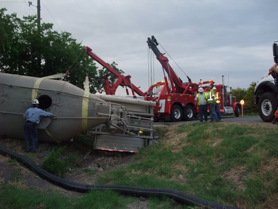 Image: Helms Garage and Pechal’s Garage simultaneously lifted the trailer from its predicament using their crane-like tow trucks.