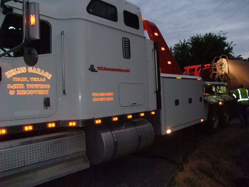 Image: Job well done — Keith and Margaret Helms of Helms Garage, along with Pechal’s Garage, made a difficult task look easy. In just a few minutes, the trailer was finally lifted after being on its side for four hours. Traffic flow on Hwy. 77 was running smoothly by 10:00 p.m.