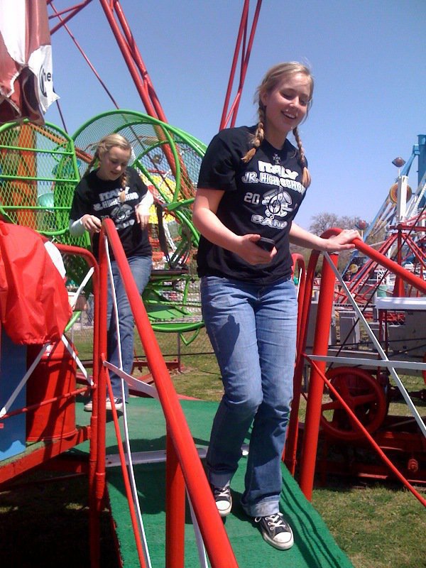 Image: I’m still spinning! — Madison Washington is followed Kelsey Nelson as they dizzily exit a ride at Sandy Lake.