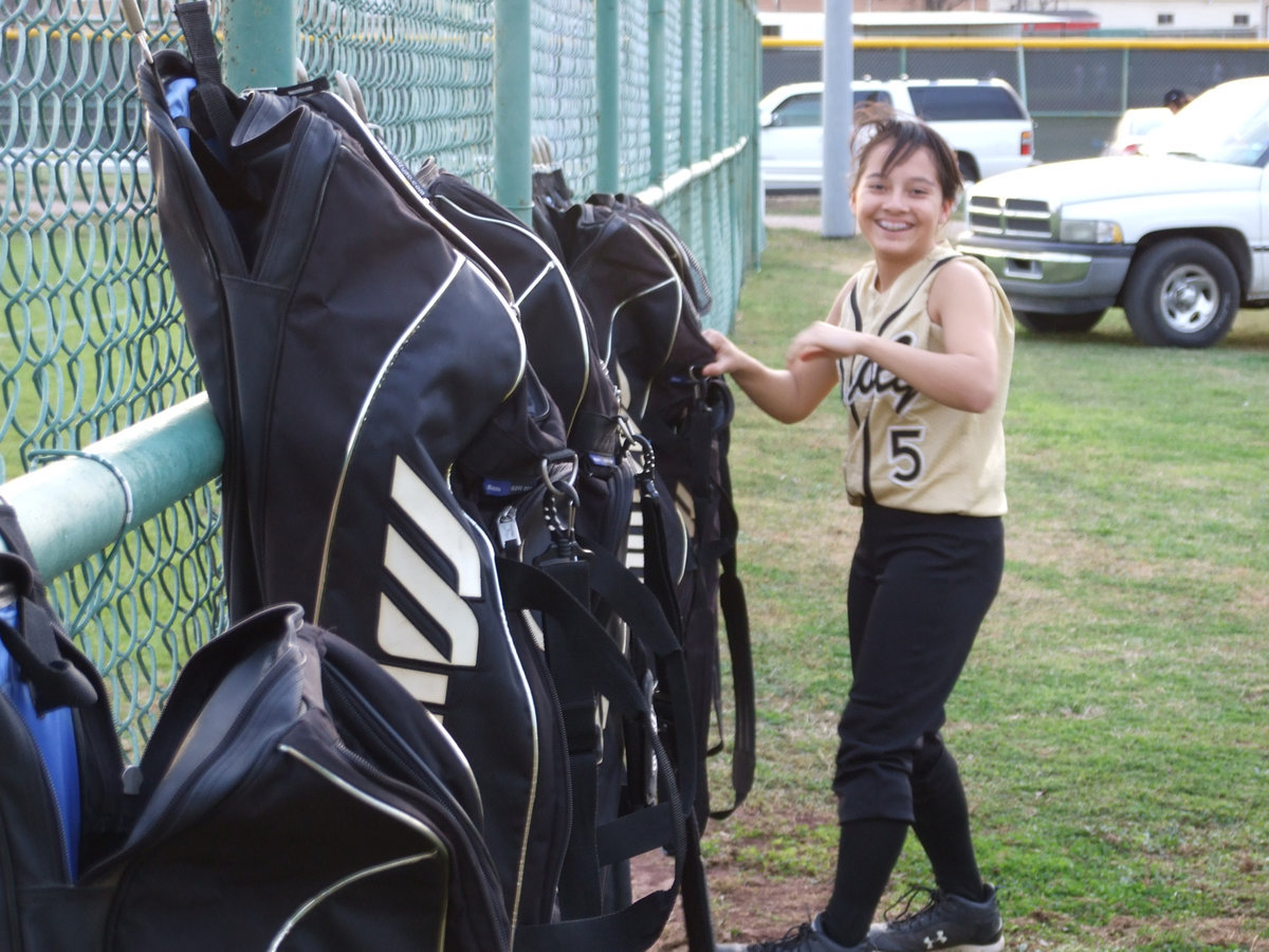 Image: Camera Shy — Lupita Luna gets caught with her hand in the bag.