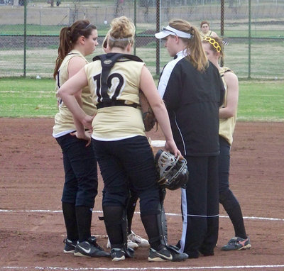 Image: Infield Huddles — Coach Reeves discusses strategy with her infielders.