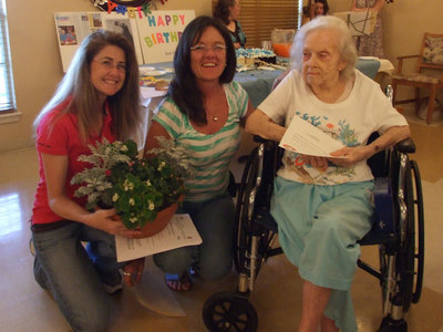 Image: Having a Good Time — Rhonda Cockerham, Terri Murdock presented June Frame her plant and proclamation.