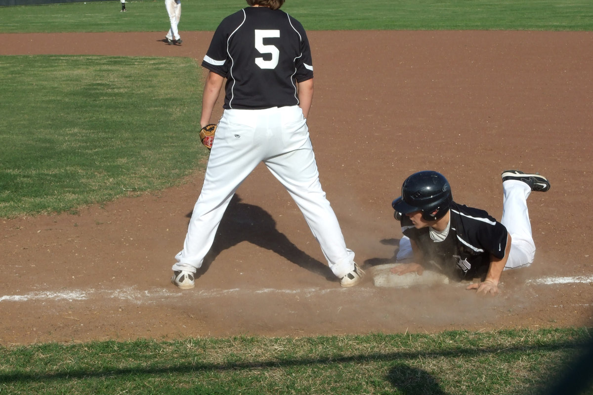 Image: Chase is safe — Tempting the pitcher a bit, Chase Hamilton returns to first before the ball gets there.