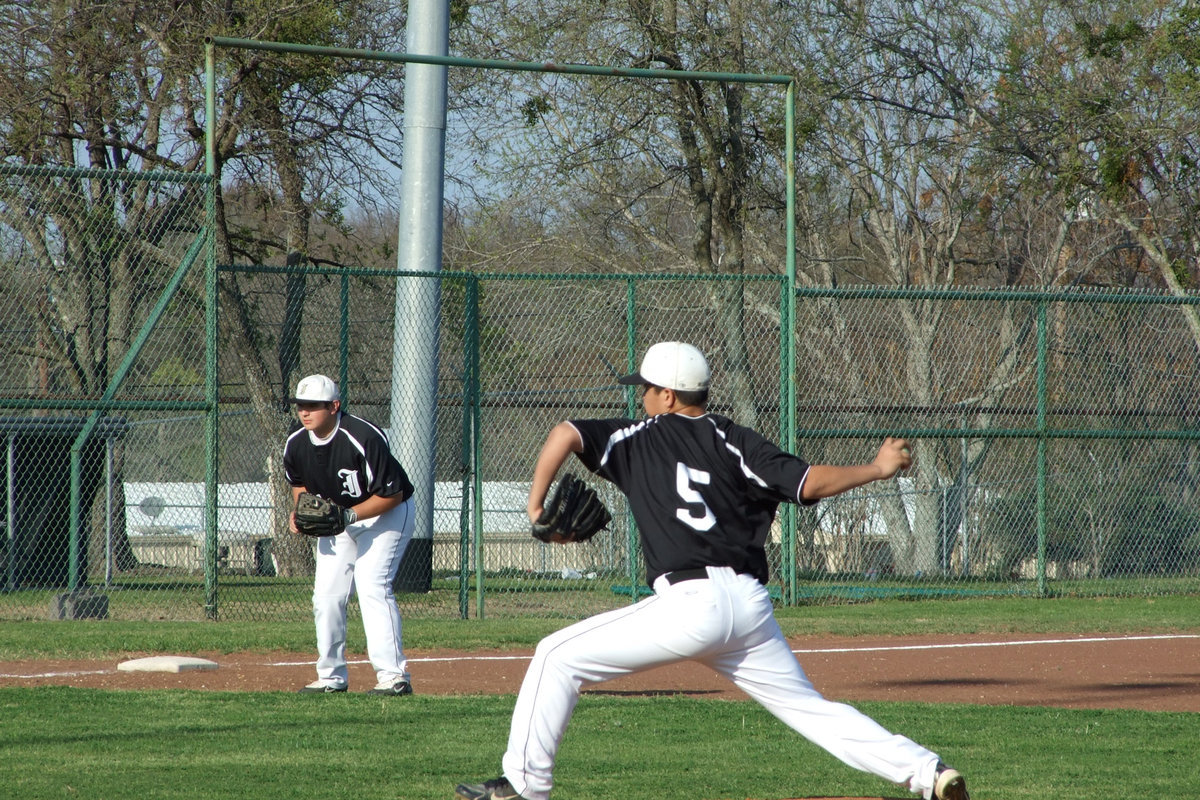 Image: Reid sends heat — Reid Jacinto takes careful aim while 3rd baseman Kevin Roldan looks on.