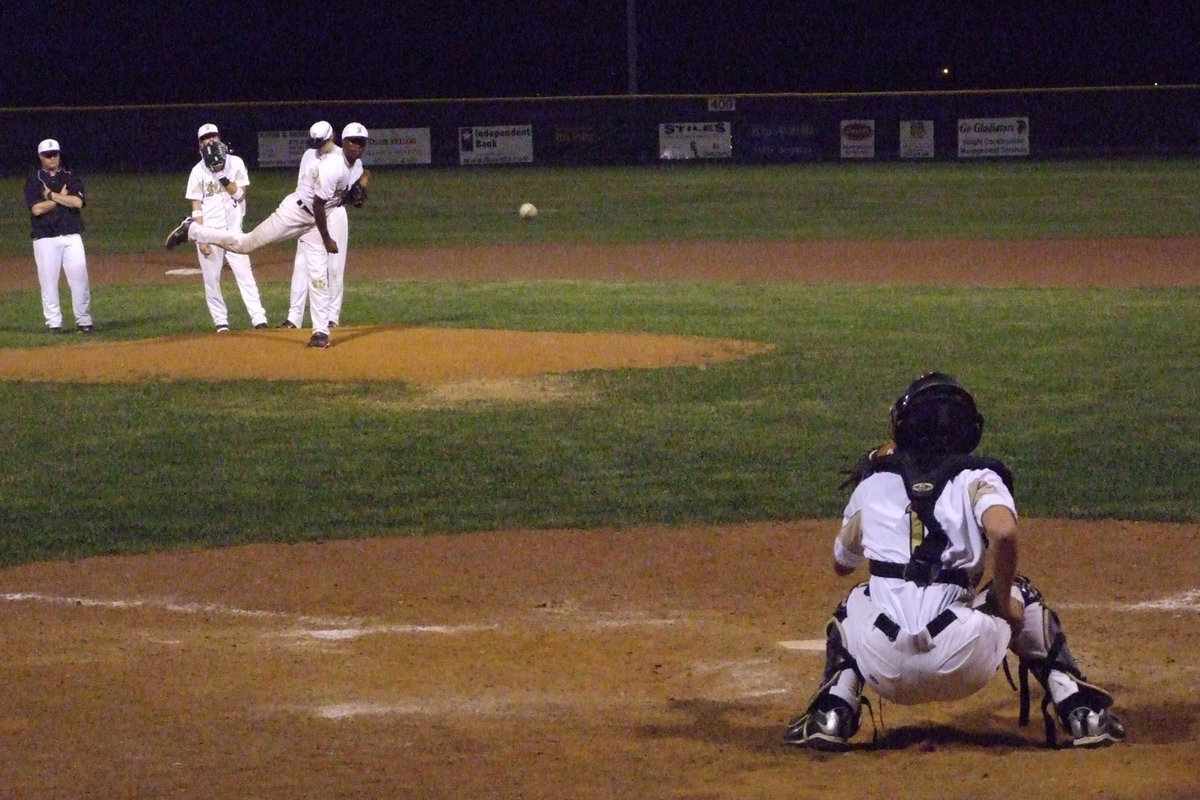 Image: Jasenio gets warm — Coach Ward waits on his third pitcher change to continue the game.