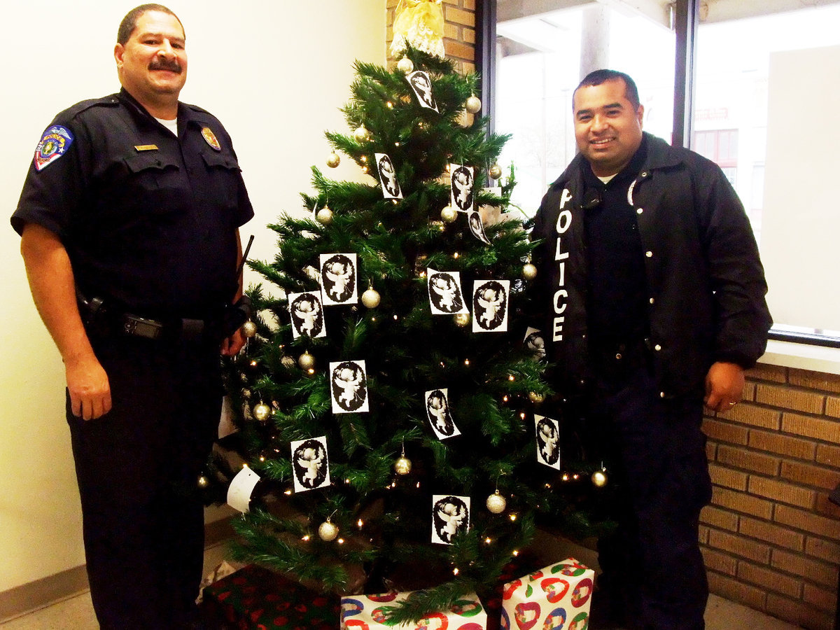 Image: Milford’s Angel Tree — Milford Police Chief Carlos Phoenix and officer Manny Valdez encourage you to come to Milford Police department and adopt an “Angel”.