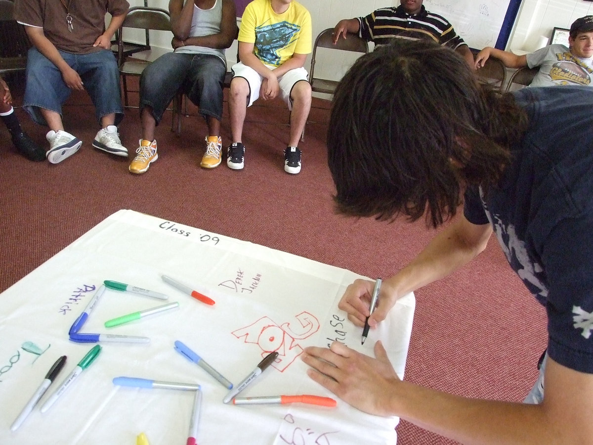 Image: Chase signs for posterity — The Methodist ladies provided a banner for the Class of 2009 to have at reunions and homecomings.