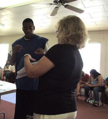 Image: Butter plays the game — Darrin Moore plays the trivia game with Jan Parker of the Methodist Church.