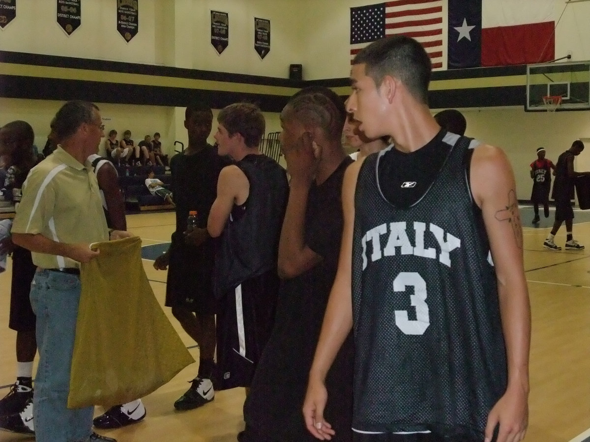 Image: Oscar and the guys — Oscar Gonzalez and his teammates gather their gear after their first summer league game against Ferris.