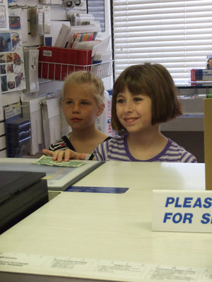Image: The Price Is Right — This young lady was really happy to purchase her stamp.