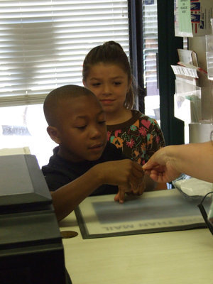 Image: How Much? — Another student purchasing a stamp.