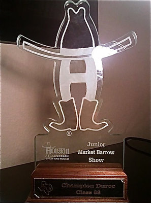 Image: Class winner trophy — Morgan Cockerham received this Champion Duroc, Class 68 trophy during the Houston Livestock Show and Rodeo after her swine, Kinsler, amazed the judge and earned 1st in class.