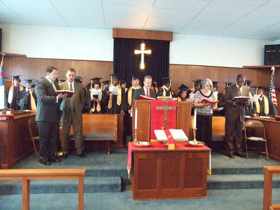 Image: Congregation sings — The ceremony is complete with a hymn.