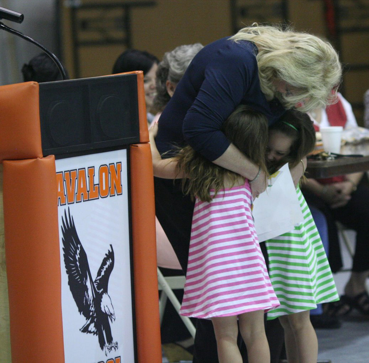 Image: Double Hugs — Two sisters gave hugs in exchange for their awards.