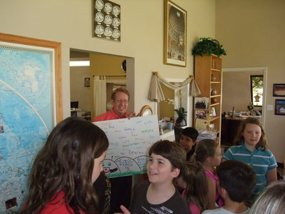 Image: Gary is thrilled — Gary Clark accepts the “Thank You” card from the students on behalf of Monolithic.