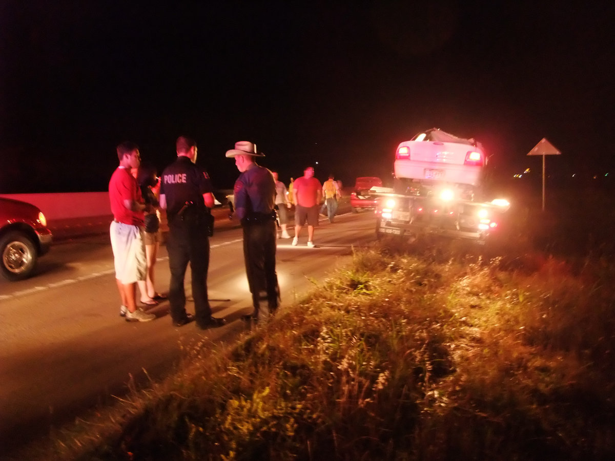 Image: Interviewing witnesses — Local Police and DPS Troopers interview passengers of the vehicle that struck the horse.