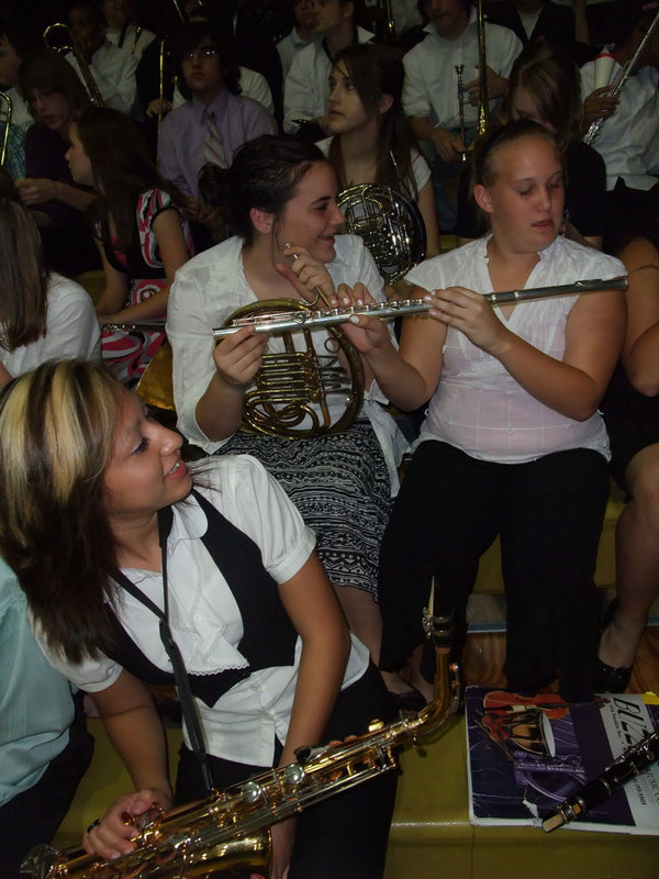 Image: Making music together — Jessica Hernandez ducks out of the way as Kaytlyn Bales and Drenda Burke try the, never before attempted, 3-handled flute.