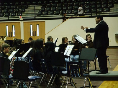 Image: Mr. Perez conducts — The 7th Grade Band puts a smile on Mr. Perez’s face along with the audience.