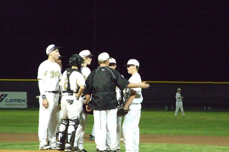 Image: How we doing? — Coach Josh Ward checks on his infield.