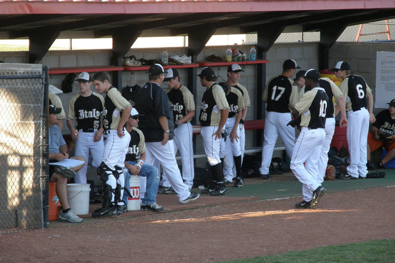 Image: Preparing for battle — Team Italy digs in inside the dugout as they get prepared for the big game.