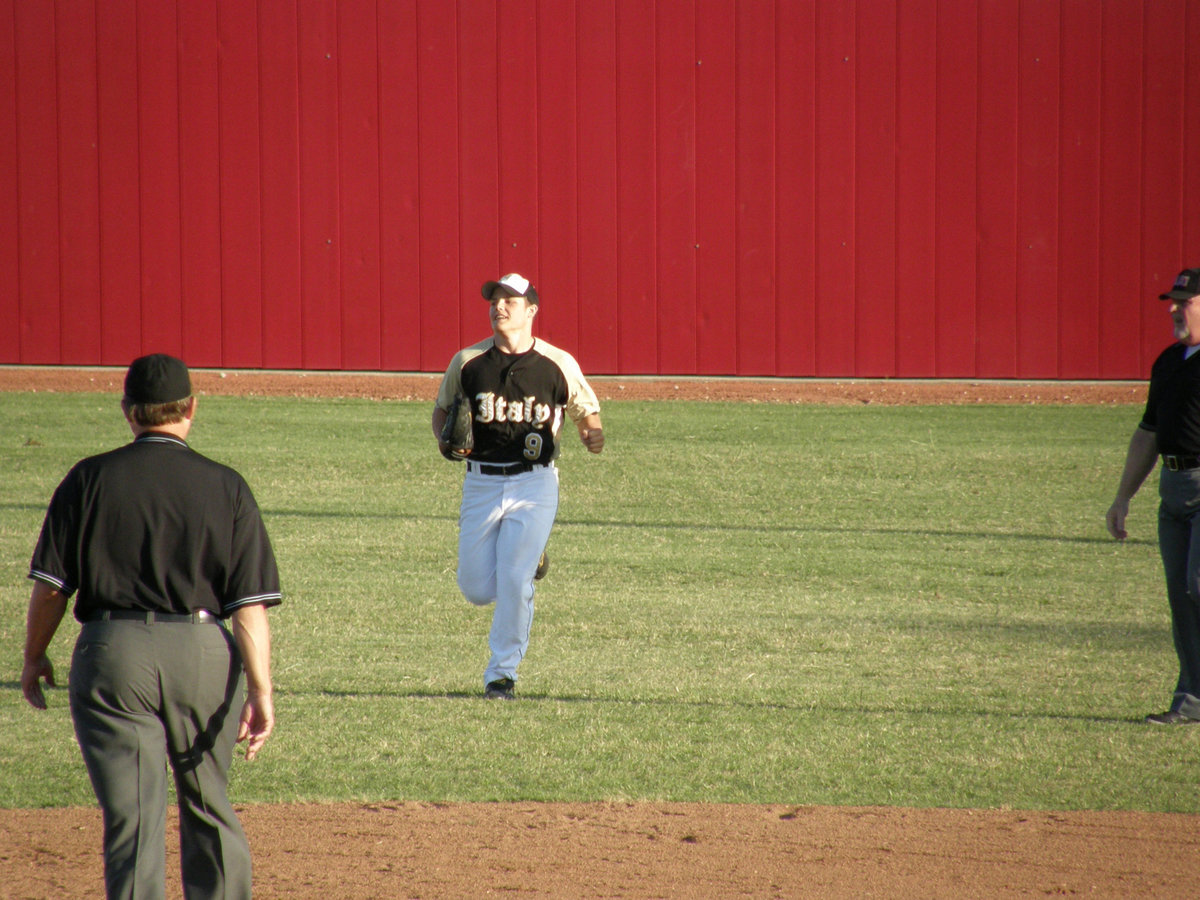 Image: Simon trots in — After a big play, Ethan Simon heads to the dugout.