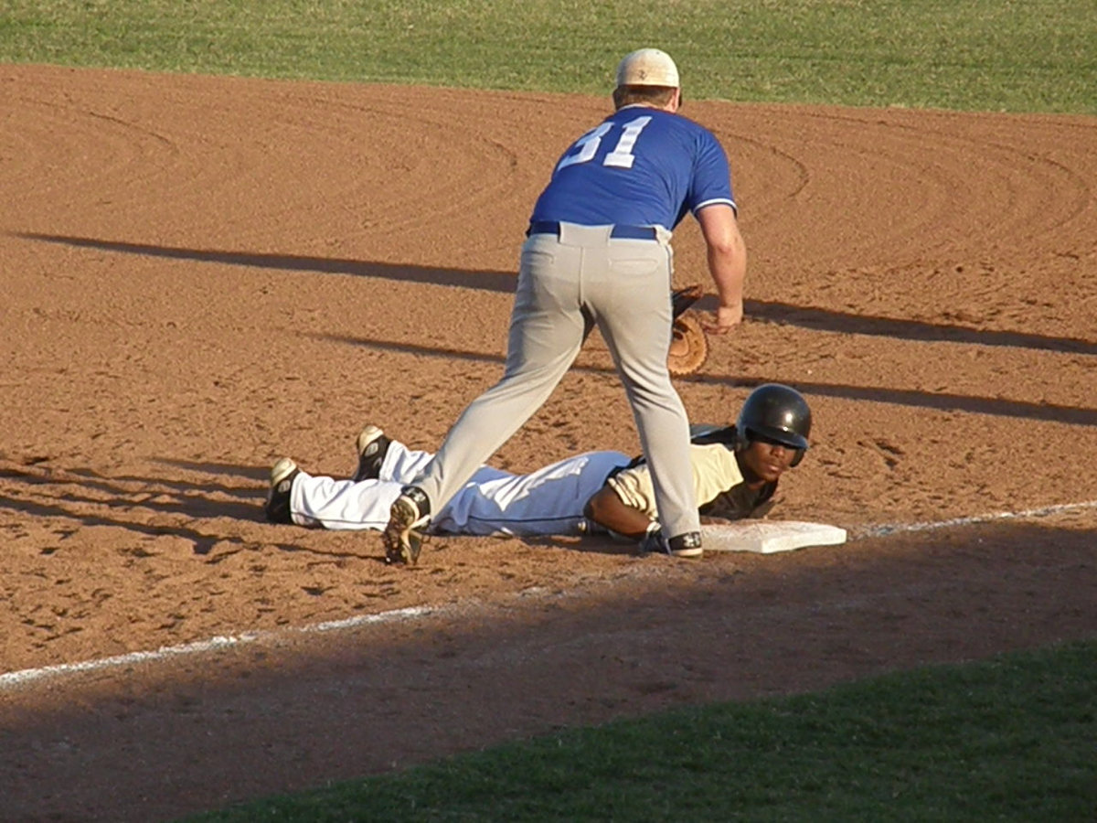 Image: Beats the throw — Desmond beats the throw and gets back to the bag in time. However, Windthorst eventually beat Italy 9-3 to claim the Area Championship.