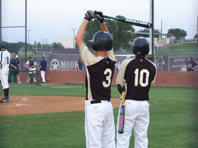 Image: Holden and Anderson — Jase Holden and Jasenio Anderson warm up for the next bat.