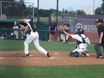 Image: Holden hits one — You can see the ball on the bat for Jase Holden.